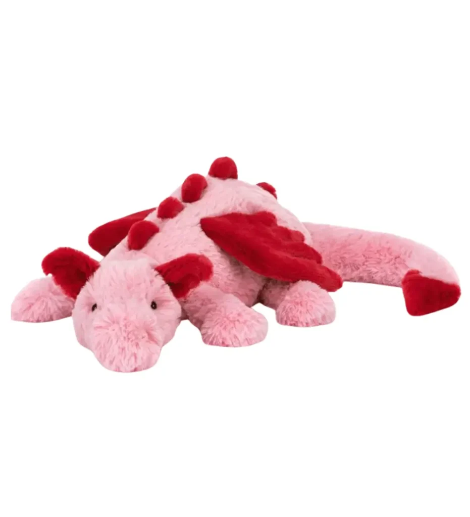 Adorable pink Jellycat Rose Dragon plush with red wings, spines, and accents, a whimsical collectible soft toy from the viral Valentine's Amuseables range.