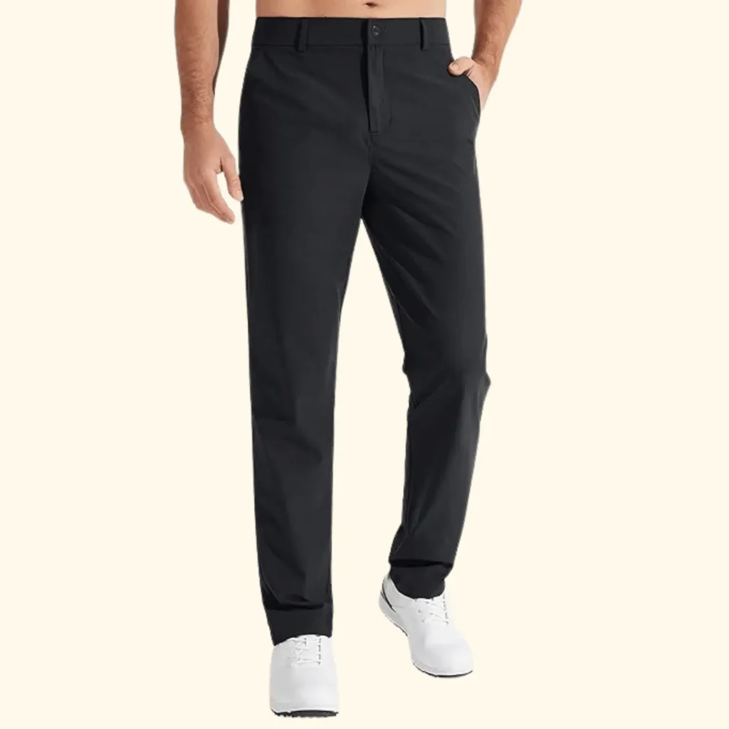 A front-facing view of a person wearing black Lululemon ABC (Anti-Ball Crushing) pants paired with white sneakers. These trousers are known for their Warpstreme fabric, which offers the stretch of performance gear while maintaining a professional, tailored appearance.