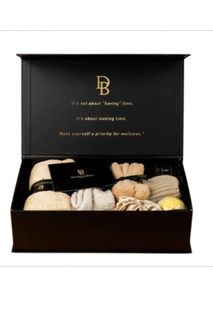 Premium black wellness gift box with inspirational message, containing cozy towels, socks, bath bomb, and relaxation essentials – perfect for self-care gifting
