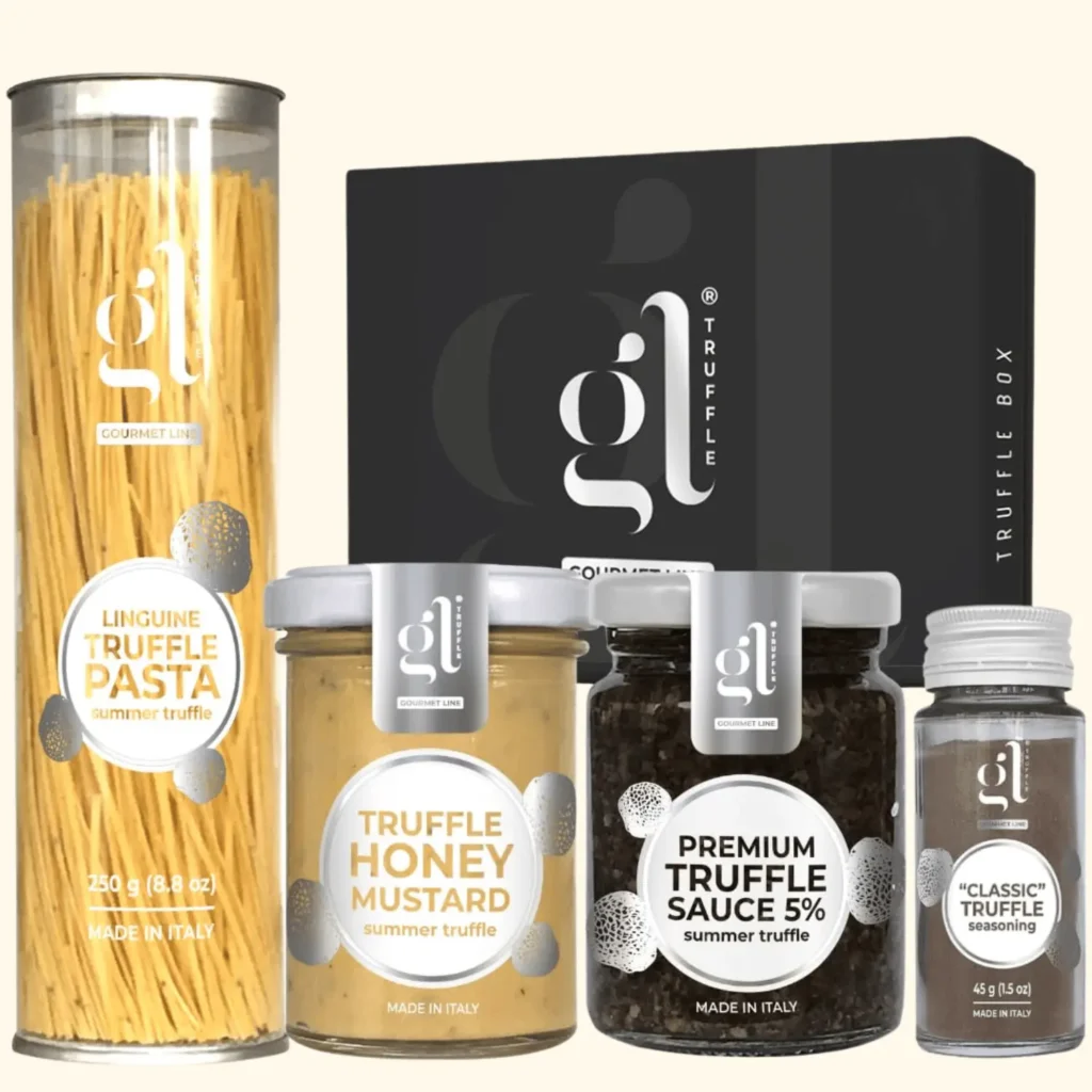 A high-quality culinary gift set from Gourmet Line featuring various truffle-infused products. The set includes Linguine Truffle Pasta, Truffle Honey Mustard, Premium Truffle Sauce (5%), and a "Classic" Truffle Seasoning, all displayed alongside a sleek black Truffle Box branded with the "GL" logo