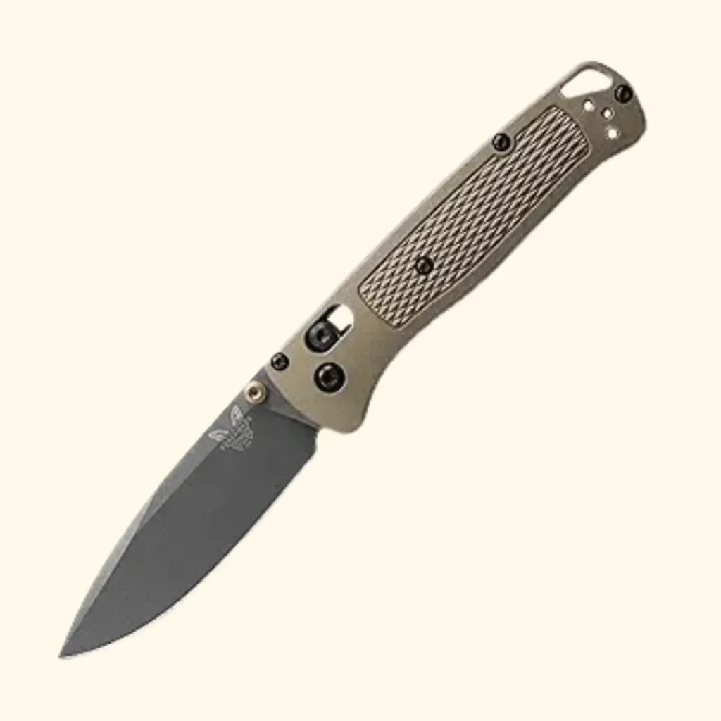 A product shot of the Benchmade Immunity folding knife in a muted Crush Orange color. The image highlights the tapered Wharncliffe blade made from premium M4 steel and the textured billet aluminum handle, which features a secure AXIS lock mechanism and a reversible pocket clip for urban everyday carry.