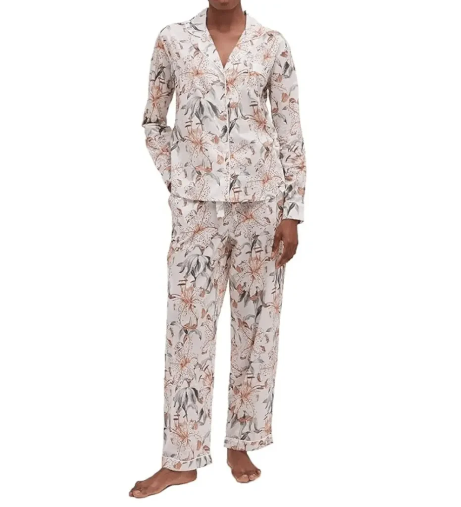 Model wearing Desmond and Dempsey long-sleeve floral print cotton pyjamas in soft pastel tones, a premium monogrammable sleepwear set for cozy Valentine's evenings.